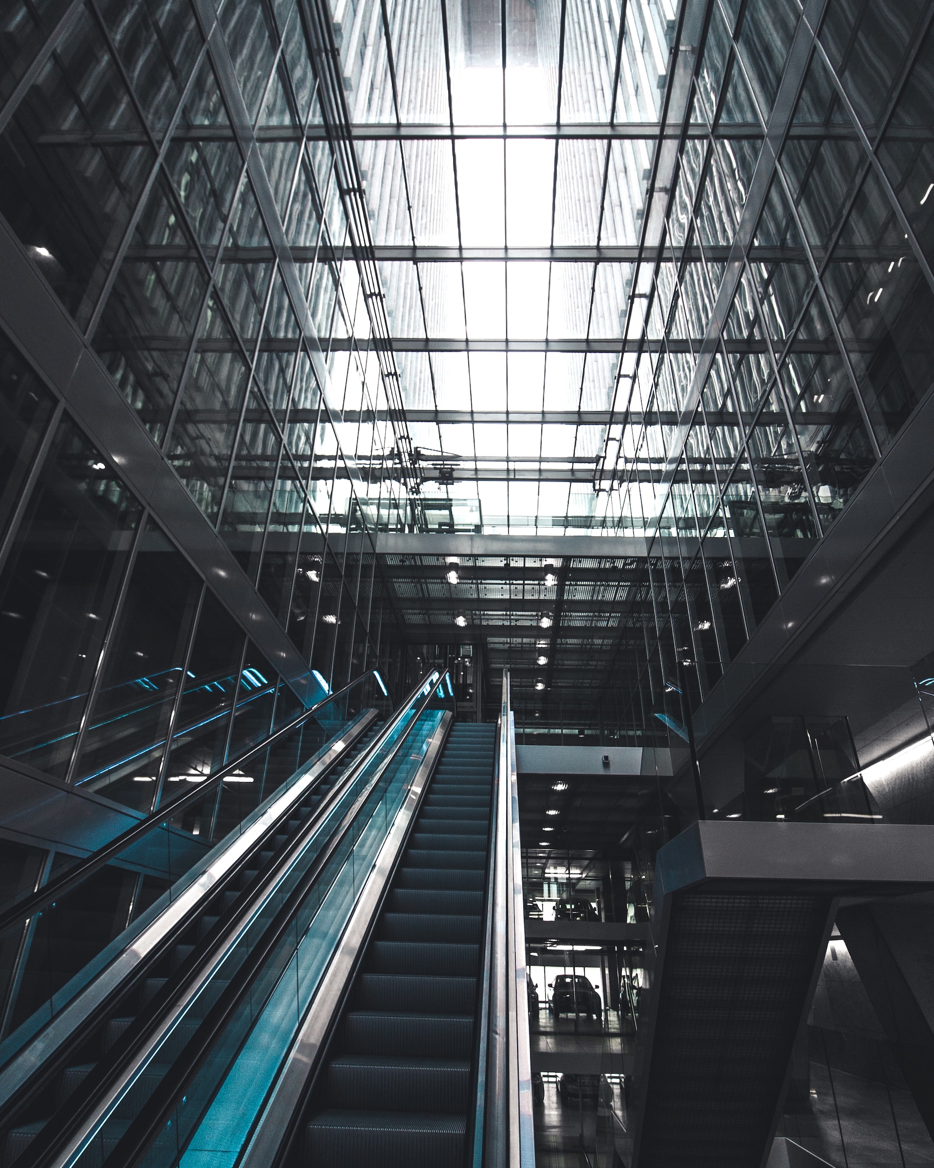 picture of an escalator in a glass building